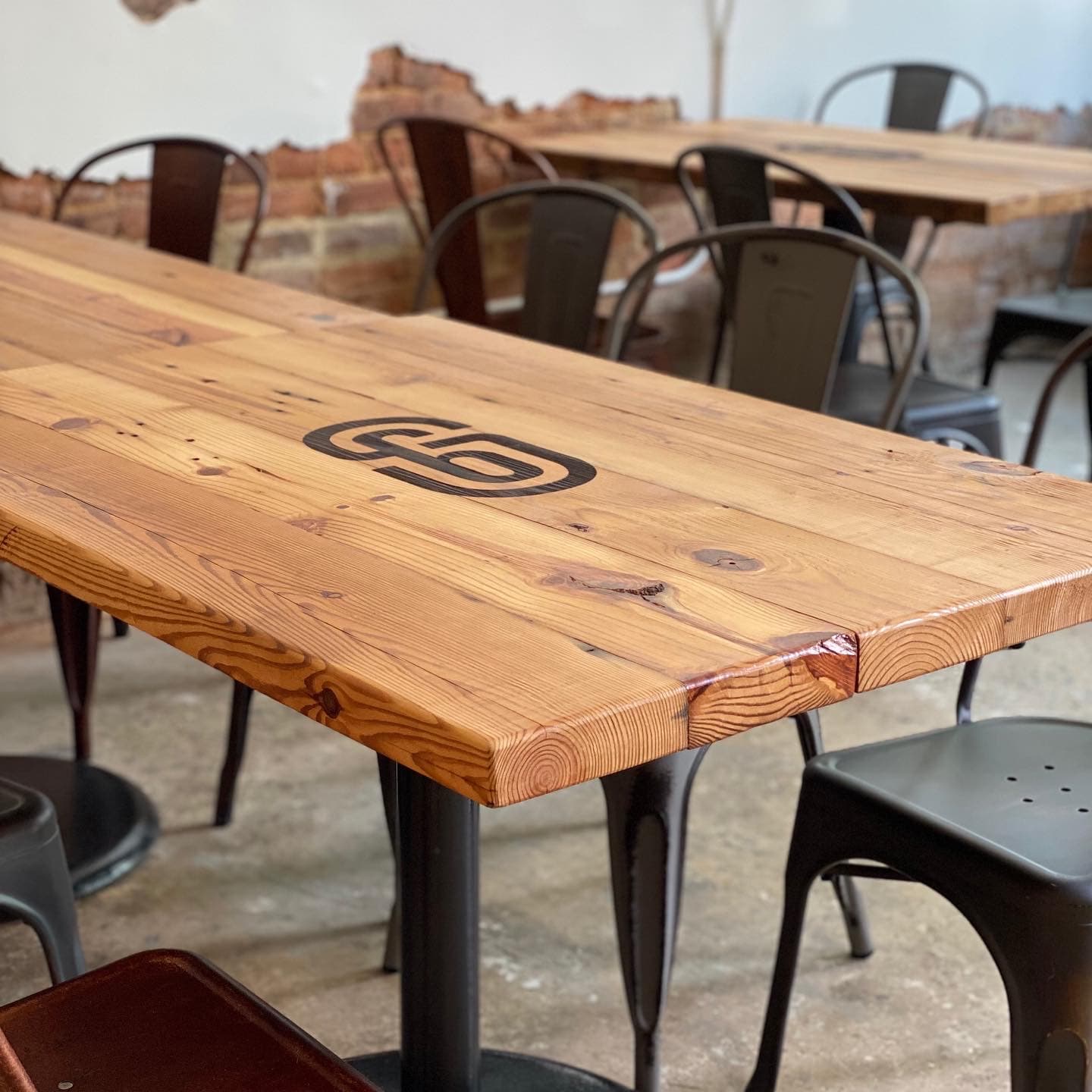 Live edge restaurant tables with custom logo brand marks