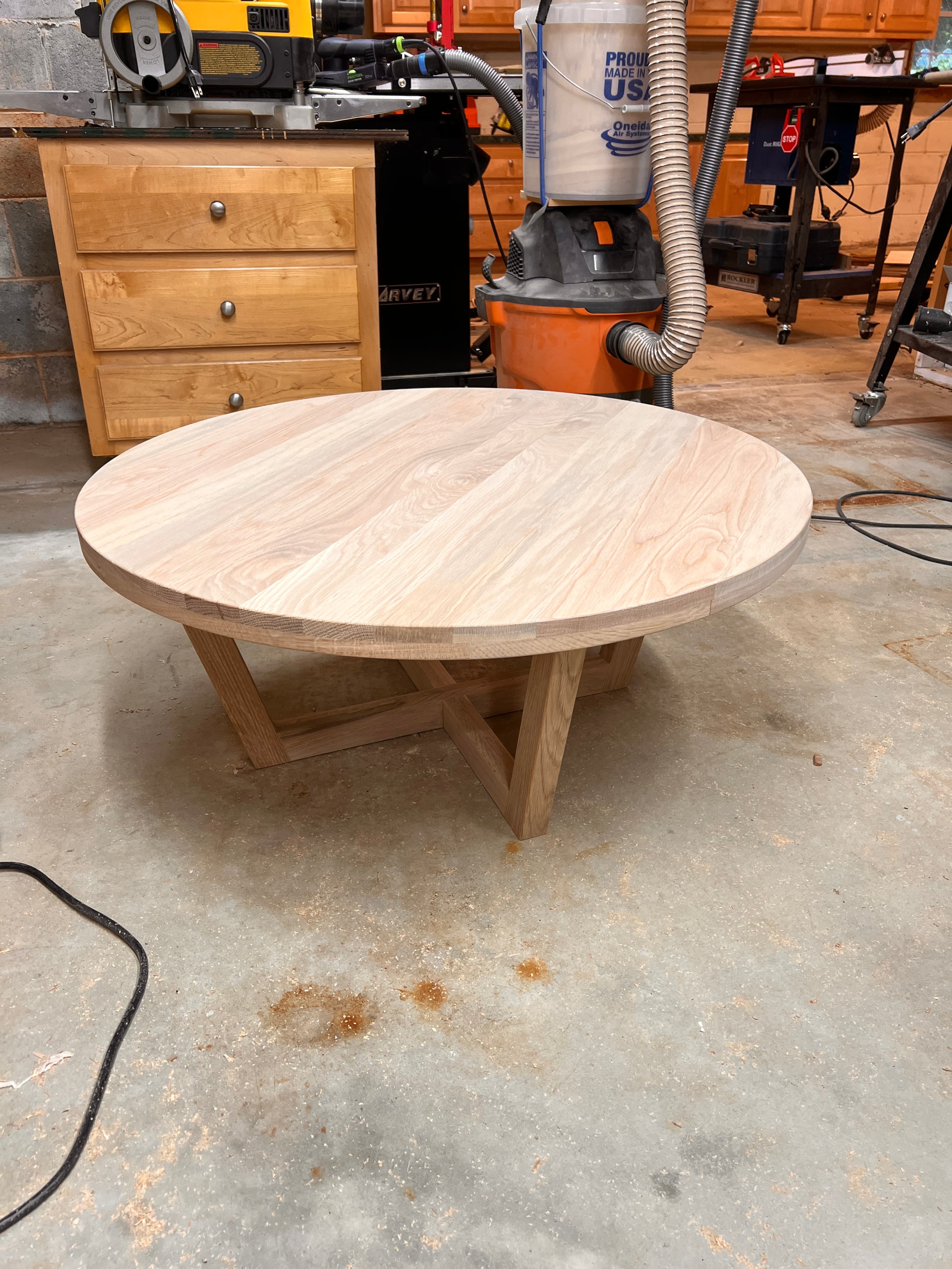 Round oak coffee table with geometric X base